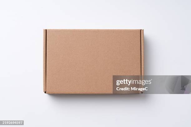 brown cardboard box on white background - cardboard box stock pictures, royalty-free photos & images