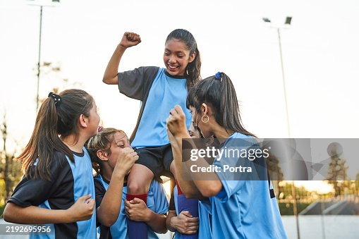 Female soccer team celebrating victory on outdoor field Female soccer team celebrating victory on outdoor field