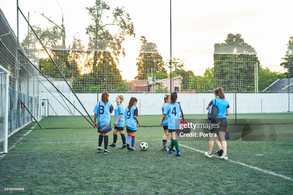 Girls soccer players arriving on field for practice