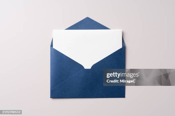 opened blue envelope with blank letter inside - busta foto e immagini stock