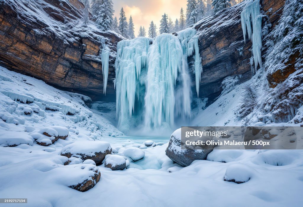A frozen waterfall in a mountainous region during the winter
