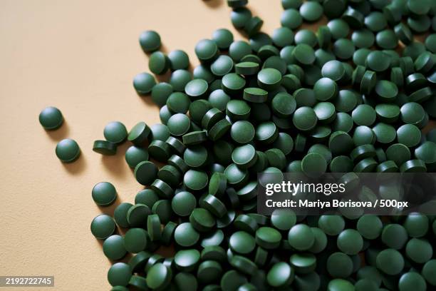 high angle view of pills on table - table font view stock pictures, royalty-free photos & images