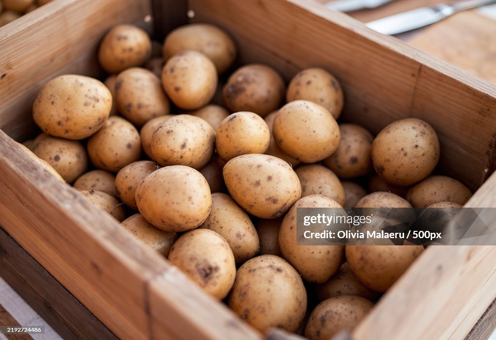 Fresh potatoes in a wooden box