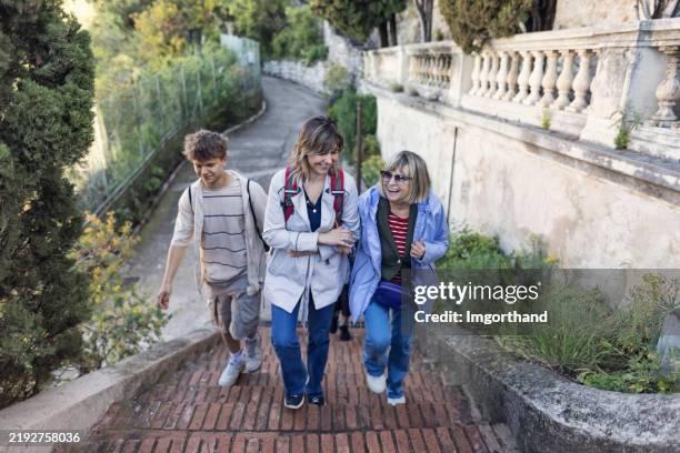 multi generation family climbing stairs to colline du château public park in nice, alpes-maritimes, france - happy smiling people multi generations stock pictures, royalty-free photos & images