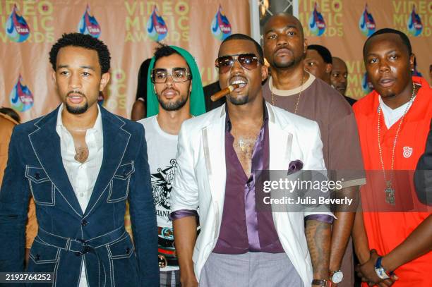 Singer John Legend , producer Taz Arnold of Sa-Ra, and rappers Kanye West, GLC , and Really Doe attend the 2005 MTV Video Music Awards at the...