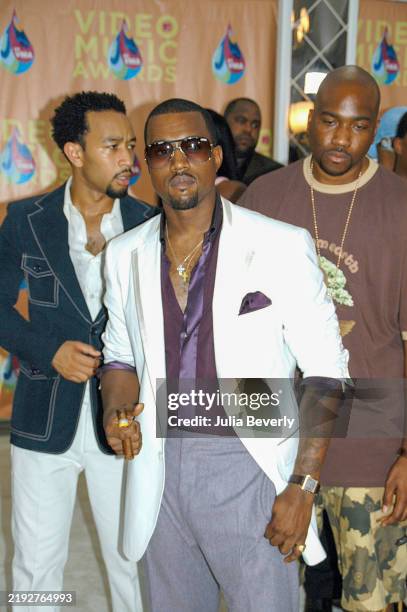 Singer John Legend and rappers Kanye West and GLC attend the 2005 MTV Video Music Awards at the American Airlines Arena on August 28, 2005 in Miami,...