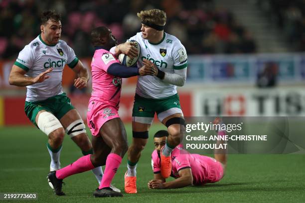 Northampton' English number eight Henry Pollack is tackled by Stade Francais' French wing Lester Etien during the European Rugby Champions Cup rugby...