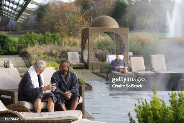 old friends embracing spa comfort - spa stock pictures, royalty-free photos & images