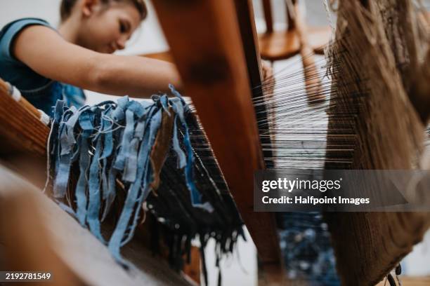 teeenage girl in a weaving course is learning to weave on a loom. new year's resolutions, developing personal creativity. - sustainable fashion stock pictures, royalty-free photos & images