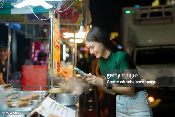 foodie enjoying food exploration at yaowarat night market. - street food festival stock pictures, royalty-free photos & images