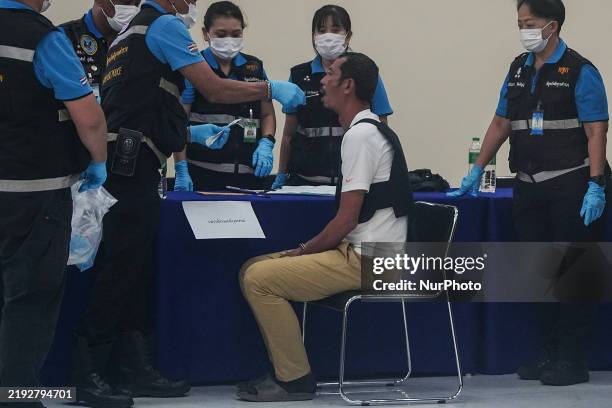 Thai national Ekalak Paenoi, a suspected gunman who allegedly kills former Cambodia opposition Member of Parliament Lim Kimya, undergoes an...
