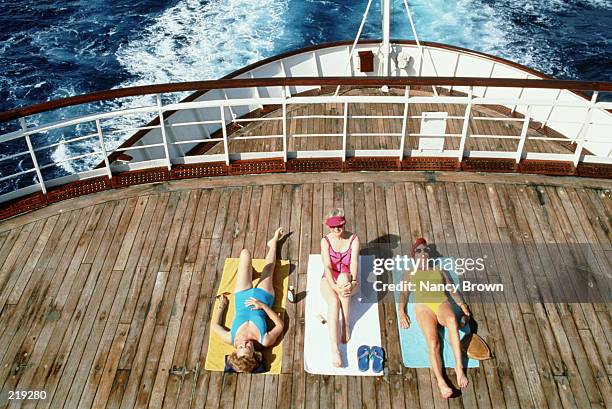 women sunbathing on oceanliner deck - cruise deck stock pictures, royalty-free photos & images