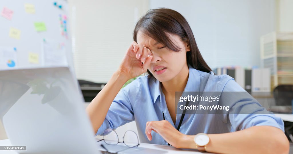 Woman eyes pain at work