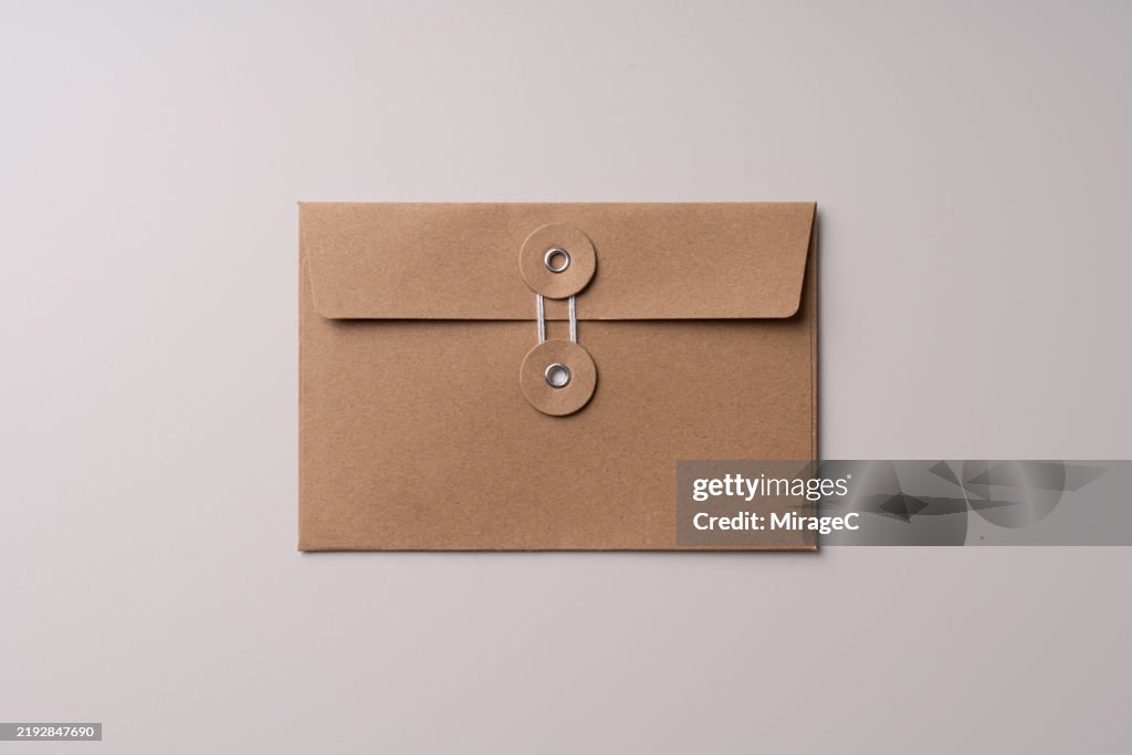 Brown Manila Envelope on Beige Background