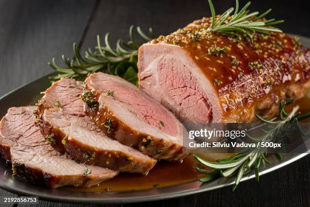 a beautifully cooked pork meat dish,sliced and presented on a plate - rosmarin bildbanksfoton och bilder
