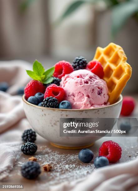 raspberry ice cream in a bowl with fresh berries and waffle - eisbecher stock-fotos und bilder