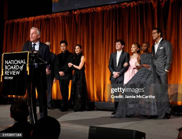 Marc Platt, Jon M. Chu, Michelle Yeoh, Ethan Slater, Ariana Grande, and Cynthia Erivo accept the Best Film Award for "Wicked" from Ryan Reynolds...