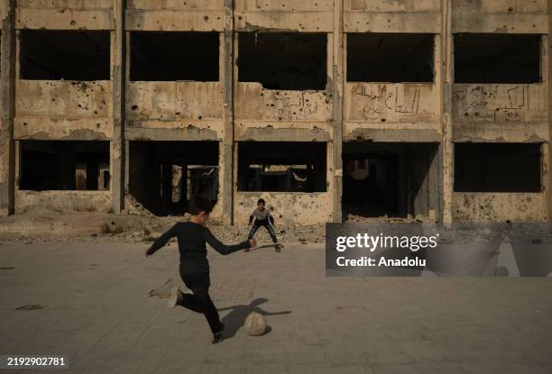 Children play football near destroyed buildings as return of the civilians has started in Syria on January 9, 2025. Homs, which is strategically...