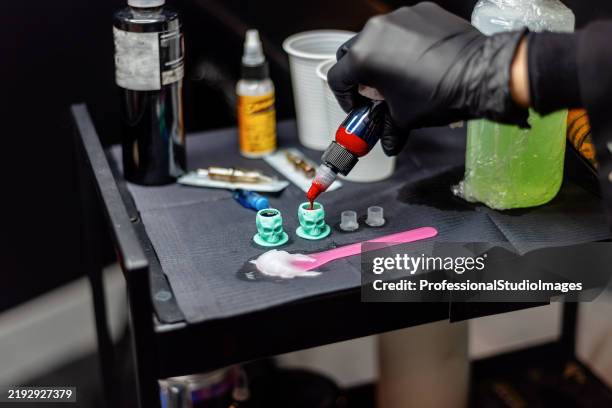 tattoo artist preparing tools with focus on sterilized equipment and ink - tattoos celtic stock pictures, royalty-free photos & images