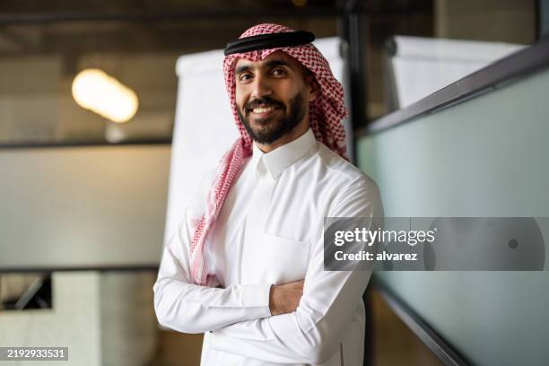 professionnel du moyen-orient en tenue traditionnelle debout dans une salle de réunion - culture saoudienne photos et images de collection