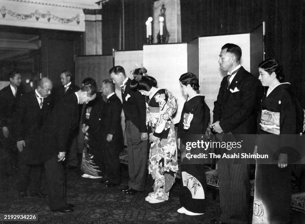 Morisada Hosokawa and Yoshiko Konoe greet guests at their wedding on April 16, 1937 in Tokyo, Japan.