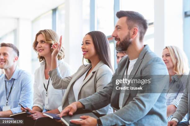 group of pleased people at business conference - asking stock pictures, royalty-free photos & images