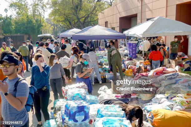 Volunteers gather donated goods in the aftermath of the Eaton Fire in Pasadena, California, US, on Saturday, Jan. 11, 2025. Firefighters are making...