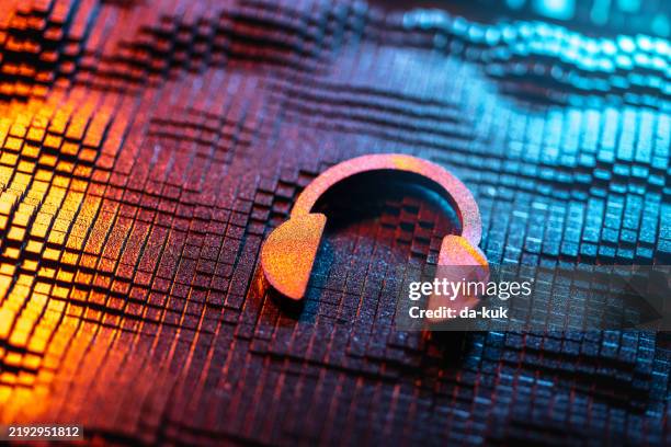 colorful close-up of metallic headset on vibrant textured material - musica imagens e fotografias de stock