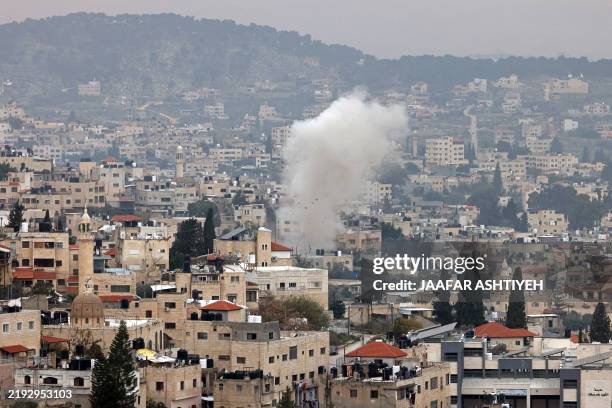 Smoke rises from Jenin in the occupied West Bank, during clashes between militants and the Palestinian Authority's security forces, inside the Jenin...