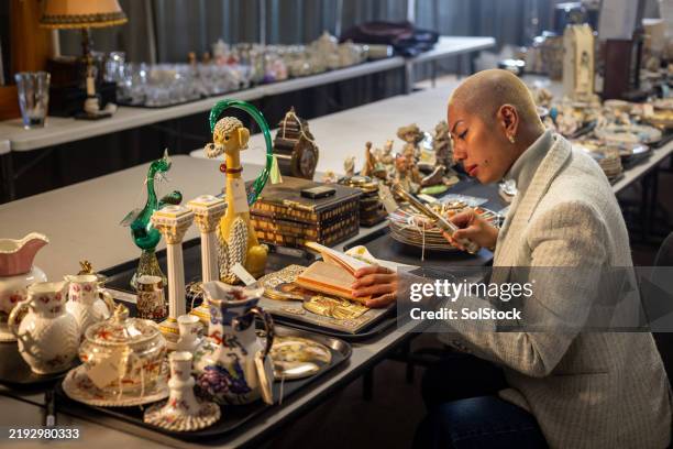 auction professional analysing priceless antiques - antique stock pictures, royalty-free photos & images