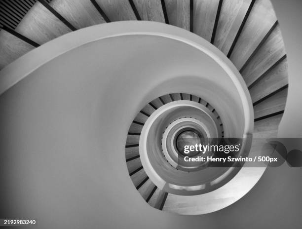 high angle view of spiral staircase - spiral staircase stock pictures, royalty-free photos & images