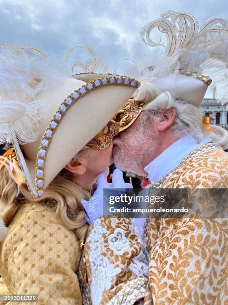 masked couple kissing at venice carnival - kissing mask stock pictures, royalty-free photos & images