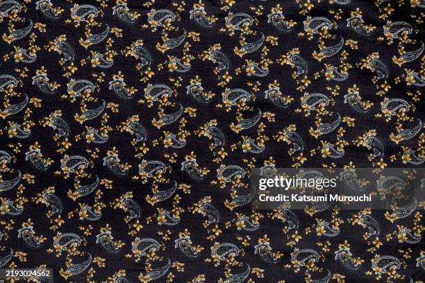 paisley pattern black cloth textured background - indian cloth pattern stock pictures, royalty-free photos & images