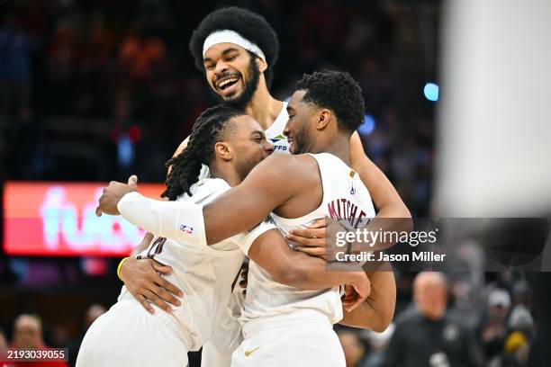 Darius Garland Jarrett Allen and Donovan Mitchell of the Cleveland Cavaliers celebrate during the fourth quarter against the Oklahoma City Thunder at...