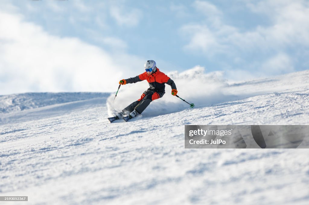 Teenage boy spending winter holiday skiing in mountain