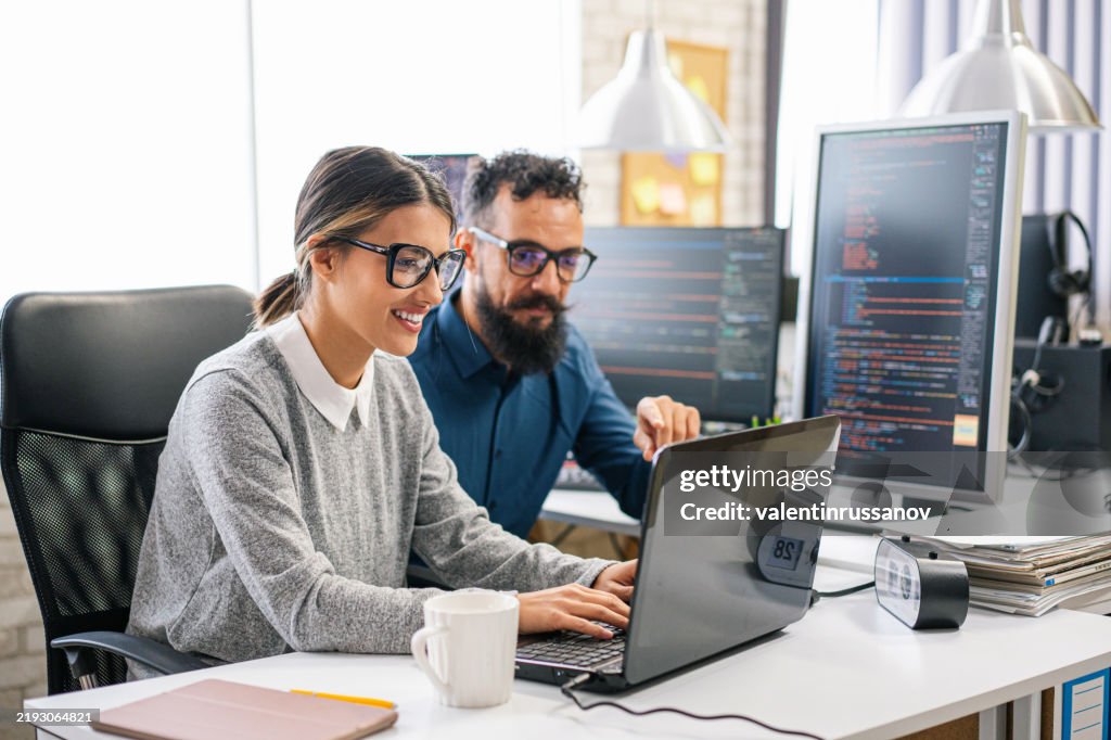 Couple, software engineer developer use computer, work on program coding together at the office. Programming language development technology, freelance job concept