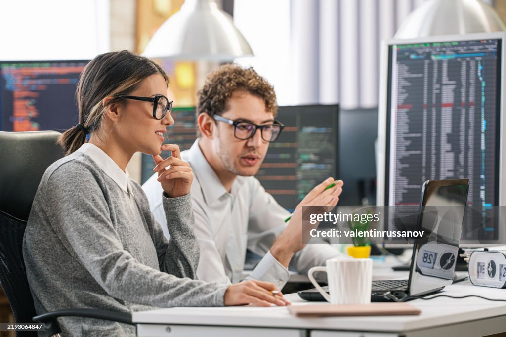 Couple, software engineer developer use computer, work on program coding together at the office. Programming language development technology, freelance job concept