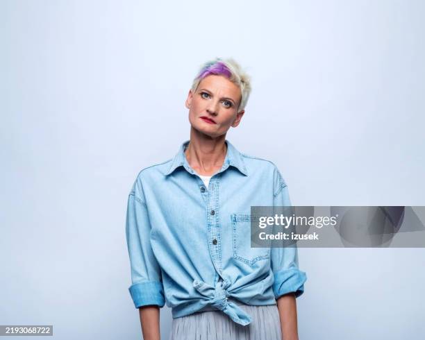 portrait of worried mature woman - mature woman portrait isolated stock pictures, royalty-free photos & images