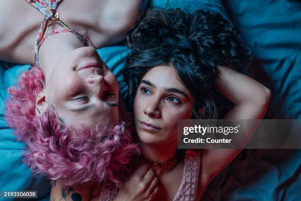 girlfriends resting together on bed - friends no makeup stock pictures, royalty-free photos & images