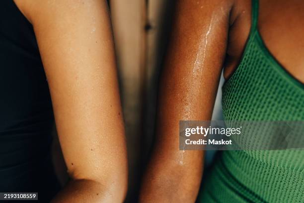 high angle view of sweaty hands of female friends in sauna - svett bildbanksfoton och bilder