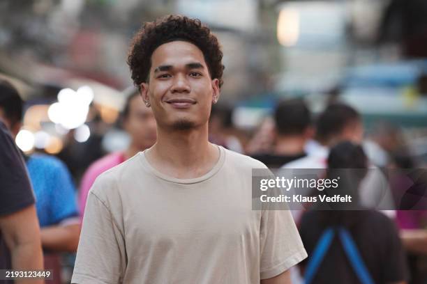 young man with smirking face - sourire narquois photos et images de collection