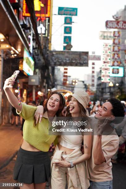 young woman taking selfie with friends - thailand tourism stock pictures, royalty-free photos & images