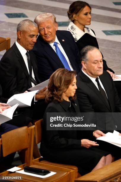 President-elect Donald Trump speaks with former U.S. President Barack Obama during the state funeral for former U.S. President Jimmy Carter at...