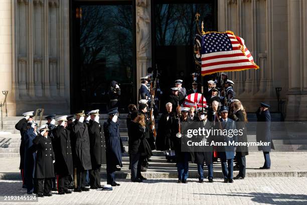 Military Body Bearers carry the flag-draped casket bearing the remains of former U.S. President Jimmy Carter from the Washington National Cathedral...