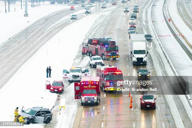 In an aerial view, First Responders attend to a vehicle collision during a winter storm on January 09, 2025 in Plano, Texas. A winter storm warning...
