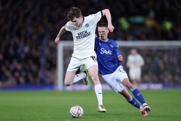 George Nevett of Peterborough United holds off a challenge from Harrison Armstrong of Everton during the Emirates FA Cup Third Round match between...