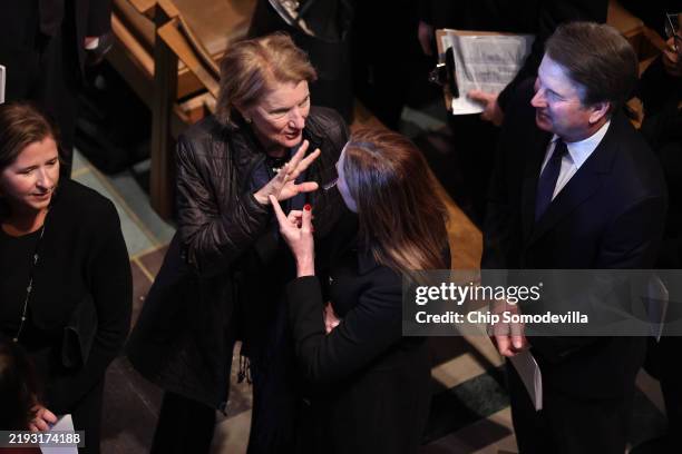 Sen. Shelley Moore Capito talks with U.S. Supreme Court Justice Amy Coney Barrett as they and Justice Brett Kavanaugh and his wife Ashley Estes...