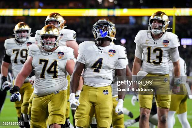 Jeremiyah Love of the Notre Dame Fighting Irish celebrates with teammates after running the ball for a touchdown during the fourth quarter against...