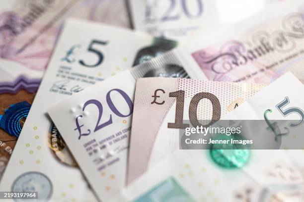 british pound sterling banknotes and coins. close up of bank of england notes. - coin stock pictures, royalty-free photos & images