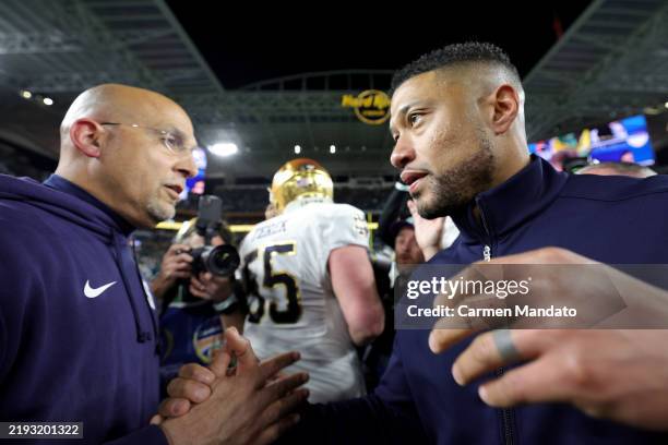 Head coach James Franklin of the Penn State Nittany Lions shakes hands with head coach Marcus Freeman of the Notre Dame Fighting Irish following the...